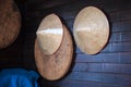 Vintage woven products bamboo wooden farmer hats and threshing basket or tray hanging on rustic wooden wall. Agricultural, Tradi