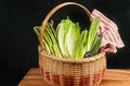 Vintage woven reed basket of organic, green vegetable