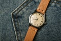 Vintage wristwatch with luxury italian leather strap and brown trendy oxford shoes. Classic timepiece mechanical watch.