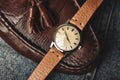 Vintage wristwatch with luxury italian leather strap and brown trendy oxford shoes.