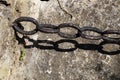 vintage wrought iron chain on old stone wall Royalty Free Stock Photo