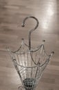 Vintage wrought iron umbrella stand with parquet background