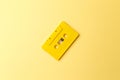 Vintage yellow audio cassette on bright yellow background. Audio cassettes with magnetic tape Royalty Free Stock Photo