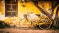 Vintage yellow bicycle leaning against retro wall. Tuscan vibe, old school travel Royalty Free Stock Photo