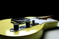 Vintage yellow - blond finish telecaster guitar on a black background
