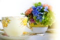 Vintage Yellow Bone China Tea Cup And Saucer Set And Flowers Arranged In Teacup On A Bright Sunny Day. Concept Of Mother`s Day