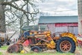 Vintage Yellow Farm Tractor by Red Barn