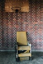 Vintage Yellow Patient Chair in Sunroom - Abandoned Central Islip State Hospital - New York Royalty Free Stock Photo