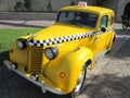 Vintage yellow taxi with checkers in the Park in summer Royalty Free Stock Photo