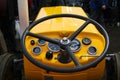 Vintage yellow tractor and steering wheel