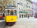 Vintage yellow tram in the city center on the sunny spring day, Praca da Figueira, Lisbon, Portuga