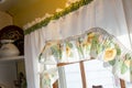 vintage yellow and white curtains in old farmhouse kitchen window