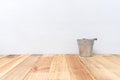 Vintage zinc bucket on wooden table and cement wall background