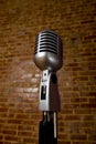 VintageMicrophone in front of brick wall Royalty Free Stock Photo