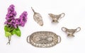Vintgae silver dishes and lilac flowers. Flat lay