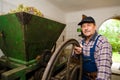 Vintner pressing grapes