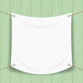 Vinyl banner blank white isolated on green pastel wood frame, mock up textile fabric empty for banner advertising stand hanging Royalty Free Stock Photo