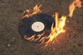 The old vinyl black plate burns on a stone surface Royalty Free Stock Photo