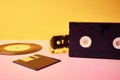 Vinyl disc, floppy diskette, vhs and tape cassete on yellow background. Retro and nostalgia concept
