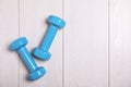 Vinyl dumbbells and space for text on wooden background, flat