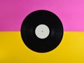Vinyl plate on a colored pastel background, retro music technology, top view, minimalism.