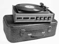 Vinyl player on an old leather suitcase isolated on a white background. Royalty Free Stock Photo