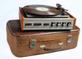 Vinyl player on an old leather suitcase isolated on a whiteVinyl player on an old leather suitcase isolated