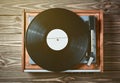 Vinyl player with plates on a wooden table. Entertainment 70s. Royalty Free Stock Photo