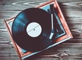 Vinyl player with plates on a wooden table. Entertainment 70s. Listen to music. Top view. Royalty Free Stock Photo