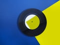 Vinyl record on blue and yellow background photo collage Royalty Free Stock Photo