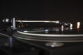 Vinyl record spinning on modern turntable. Black background. Space for text