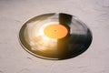 Vinyl record on a white background and sun rays. Analog sound. The concept of music, parties. Music background