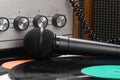 Vinyl records and microphone on the background of an old turntable Royalty Free Stock Photo