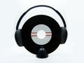 Vinyl single record with black headphones on white background