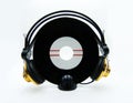 Vinyl single record with golden headphones on white background