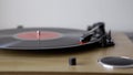 Vinyl turntable gramophone record. Included gramophone and torque plate close-up on a light background. Hand puts and takes of lp