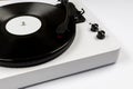 Vinyl turntable with vinyl plate on white background. Modern gramophone record player. Retro sound technology to play music Royalty Free Stock Photo