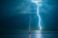 Branched lightning bolts strike down near the coast