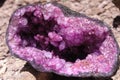 Violet amethyst broken in half with shining crystals