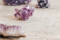 Violet amethyst crystal on wooden background. Copy, empty space for text Royalty Free Stock Photo