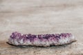 Violet amethyst crystal on wooden background. Copy, empty space for text Royalty Free Stock Photo