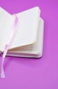 violet background and empty diary Royalty Free Stock Photo