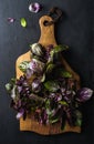 Violet basil bunch on wooden chopping board