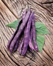 Violet beans on the old wood. Royalty Free Stock Photo