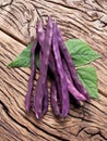 Violet beans on the old wood. Royalty Free Stock Photo