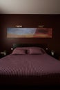 Violet bedcover on the bed Royalty Free Stock Photo