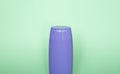 Violet blank unbranded cosmetic plastic bottle for shampoo, gel, lotion, cream, bath foam green background. Royalty Free Stock Photo