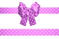 Violet bow and ribbon with white polka dots made from silk Royalty Free Stock Photo