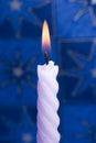 Violet candle on blue Royalty Free Stock Photo