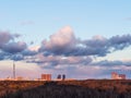 Violet clouds in blue sky over city park at dusk Royalty Free Stock Photo